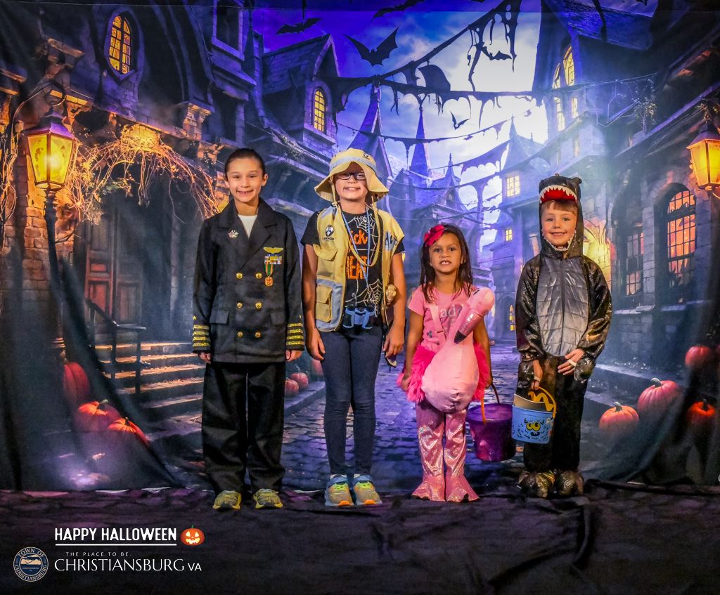 Photo of four children dressed in Halloween costumes 