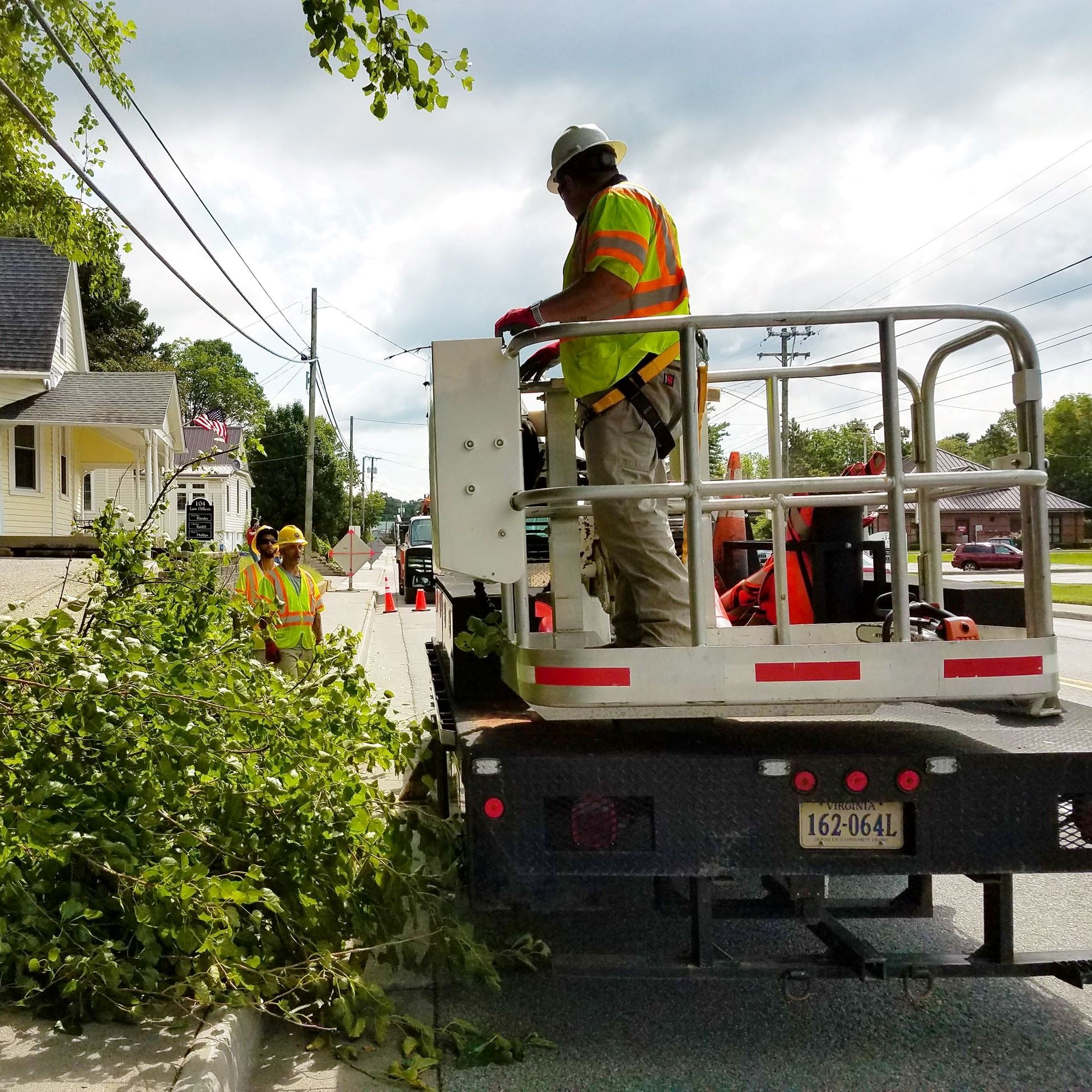 A Town employee wearing a hard hat and Public Works vest.